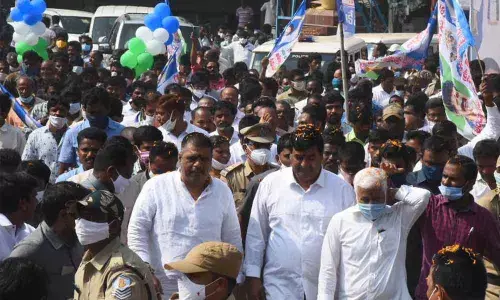 Deputy Chief Minister Dharmana Krishna Das, Rajya Sabha member V Vijayasai Reddy and Tourism Minister M Srinivasa Rao at the distribution of house pattas programme