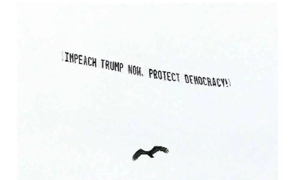 A plane towed a banner calling for Trump to be impeached to protect democracy in his remaining days in office