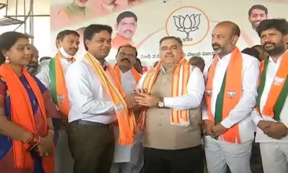 BJP State incharge Tarun Chug along with party State president Bandi Sanjay welcoming Nagarjuna Sagar Congress leader Rikkala  Indrasena Reddy into party fold in a programme held at Suryapet on Friday