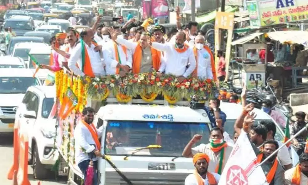 BJP party cadre and leaders participating in a bike rally in Khammam