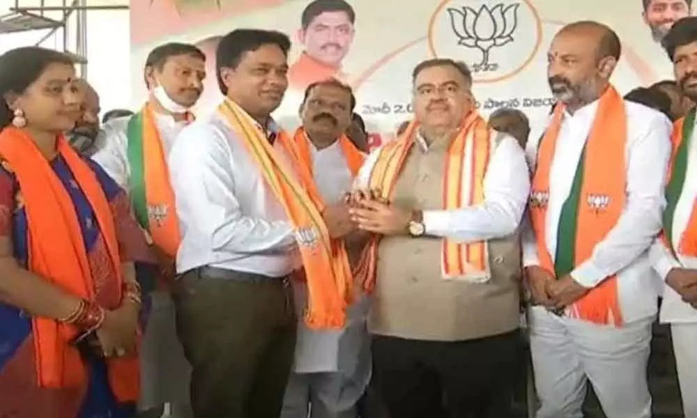 BJP State incharge Tarun Chug along with party State president Bandi Sanjay welcoming Nagarjuna Sagar Congress leader Rikkala Indrasena Reddy into party fold in a programme held at Suryapet