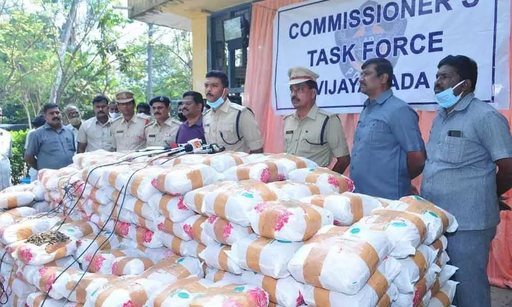 Task Force police with the seized ganja packets in Vijayawada on Saturday