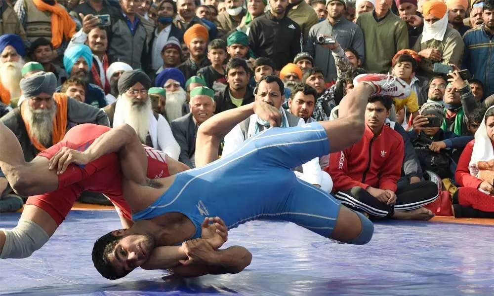 Farmers organise a wrestling competition during their protest against the new farm laws, at the Ghazipur border in New Delhi on Sunday