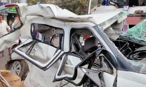 Badly mangled car at the site of the mishap