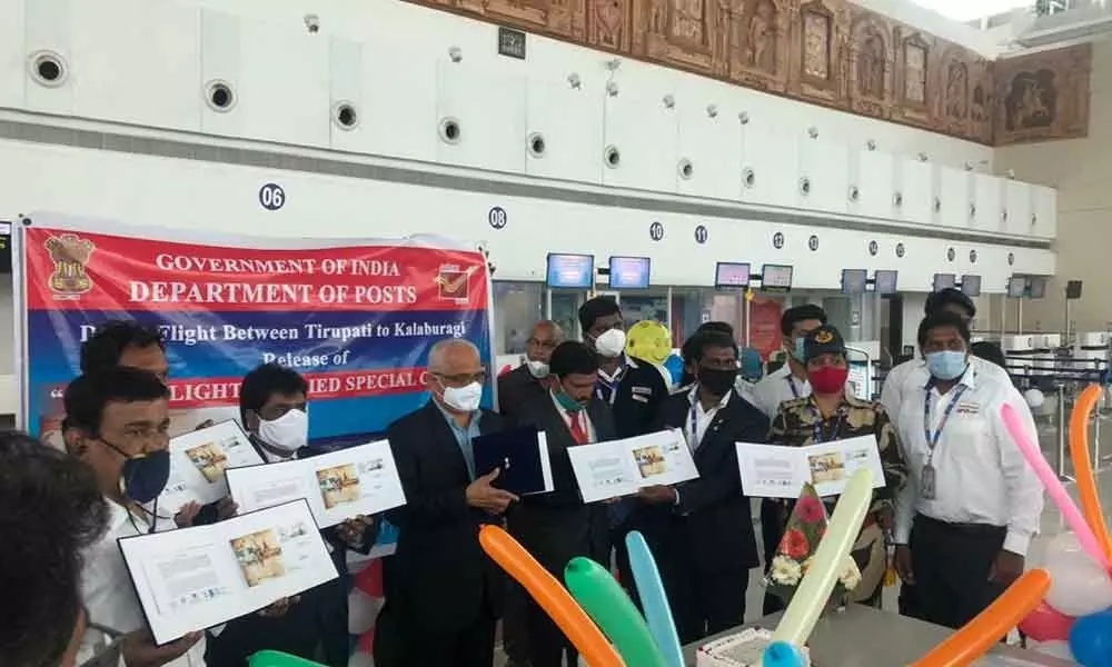 Airport Director S Suresh, Postal Superintendent A Sreenivasa Rao and others releasing a special cover on the occasion of inauguration of first flight service between Tirupati and Kalaburagi at the Tirupati Airport on Monday