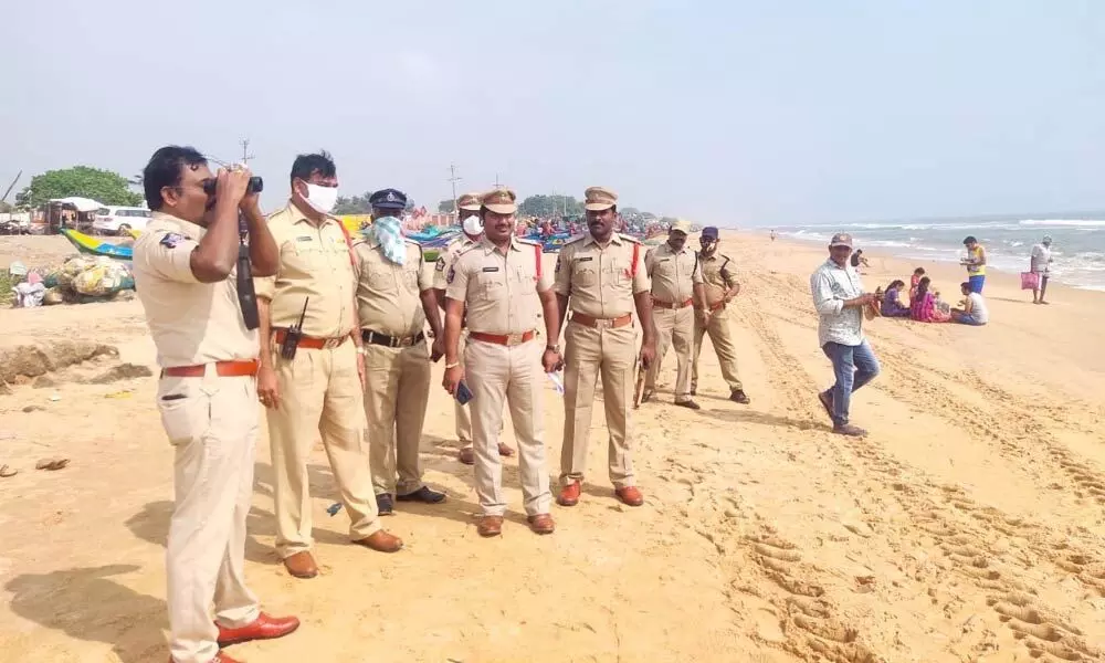 Police personnel observing the coast as part of Sea Vigil at Kothapatnam beach on Tuesday