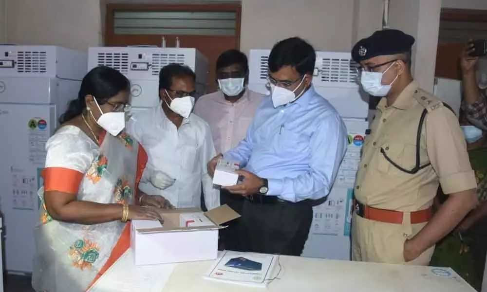 District Collector K V N Chakradhar Babu along with the SP Bhaskar Bhushan observing the vaccination stocks in Nellore on Wednesday
