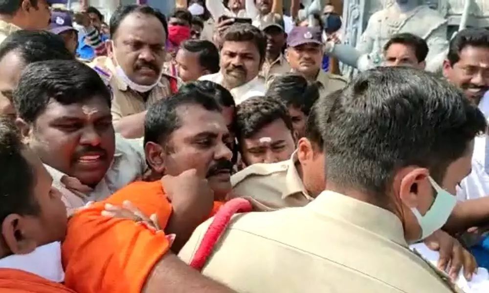 Police led by Kodad rural CI Shiva Ramakrishna arresting BJP district president Bobba Bhagya Reddy near Shivalayam at Mellacheruvu village on Wednesday