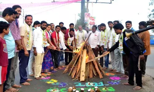 Ramagundam Municipal Corporation Mayor Dr Bangi Anil Kumar and Telangana Jagruthi representatives lighting Bhogi fire