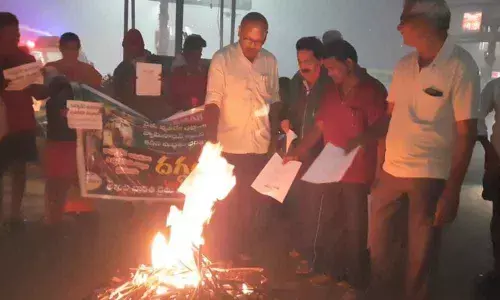 CPM leaders burning copies of new agriculture laws in Bhogi bonfire in Ongole on Wednesday