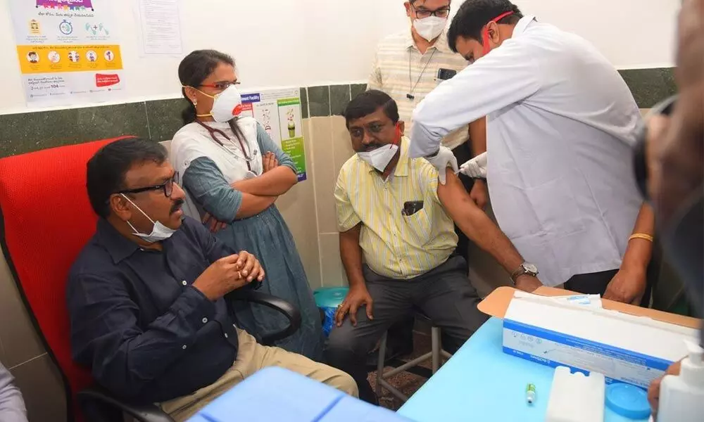 Superintendent Dr D Sriramulu receiving the vaccine as Collector Dr Pola Bhaskara looks on at the GGH in Ongole on Saturday