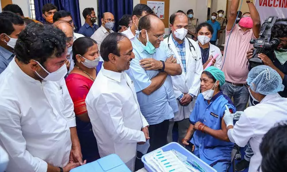 A medic administers the first dose of Covid vaccine to a frontline worker in the presence of Health Minister Eatala Rajender and Union minister G Kishan Reddy at Gandhi Hospital