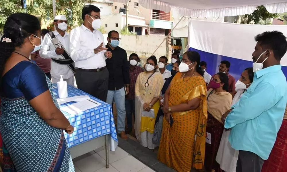 District Collector K V N Chakradhar Babu interacting with the staff members at urban health centre in Kotamitta on Sunday