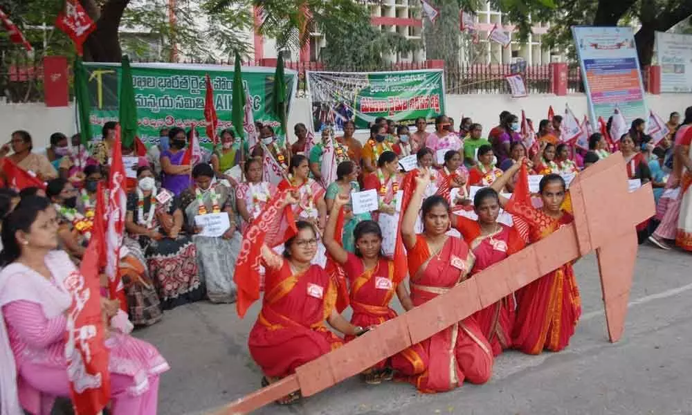 Members of women associations demonstrating in front of the Collectorate in Ongole on Monday