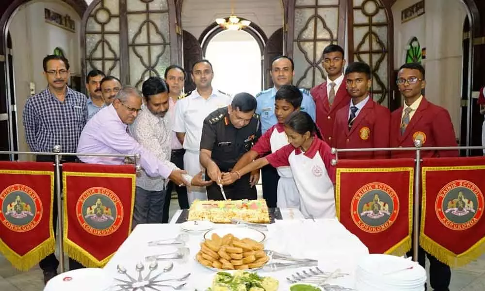 Principal Colonel Arun M Kulkarni cutting a cake on the occasion of the Raising Day of Sainik School
