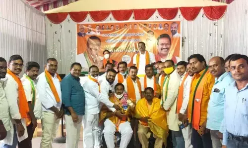 BJP leaders felicitating Gujja Satyanarayana and Kacham Guru Prasad at a meeting in Warangal on Monday