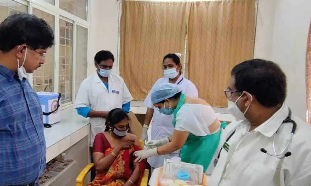 A health worker getting vaccinated as a part of the first phase of the immunisation drive in Visakhapatnam