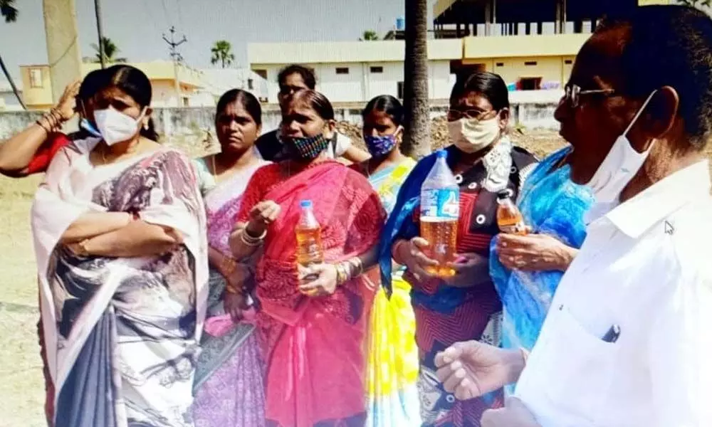 Women staging a protest carrying petrol bottles against expansion of roads near Goshala in Yadagirigutta on Wednesday