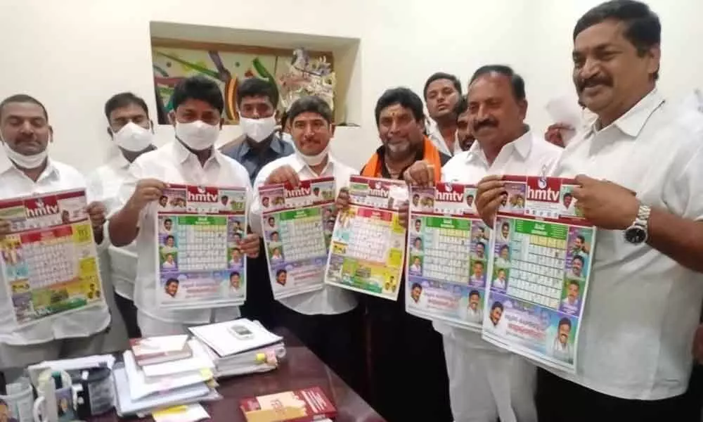 Minister Dr A Suresh, MLA K Nagarjuna Reddy and others releasing the HMTV Calendar at Markapuram on Wednesday