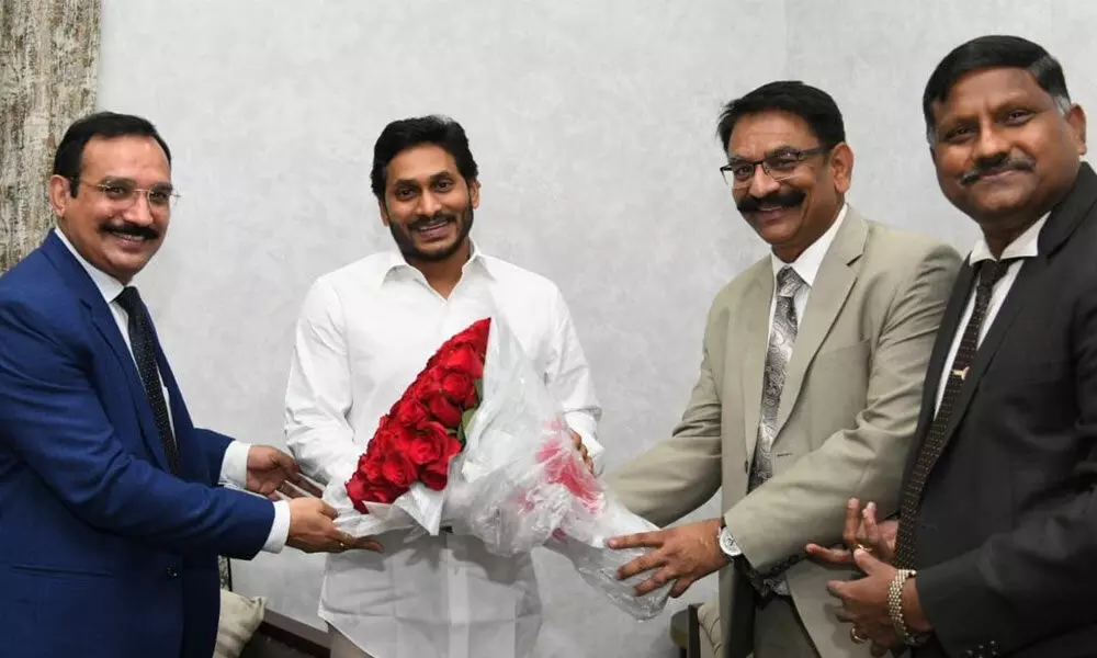 Vikramaditya Singh Khichi, Executive Director and Man Mohan Gupta, Zonal Manager of the Bank of Baroda presenting a bouquet to Chief Minister YS Jagan Mohan Reddy at the camp office at Tadepalli in Amaravati on Thursday