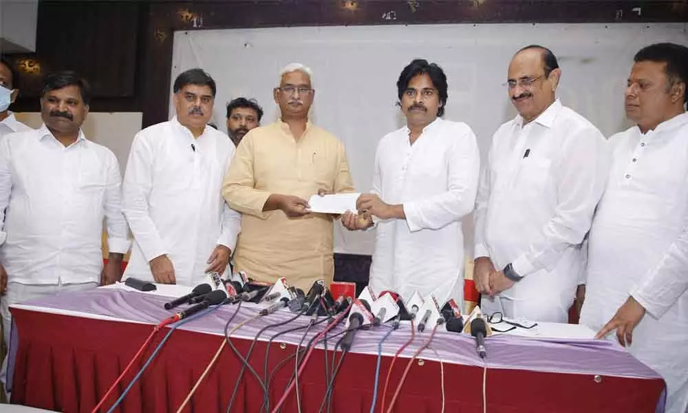 Jana Sena Party president Pawan Kalyan handing over a demand draft for Rs 30 lakh twoards contruction of Ram Mandir in Ayodhya to RSS leaders in Tirupati on Friday. Former Minister and BJP leader Kamineni Srinivas and others are seen
