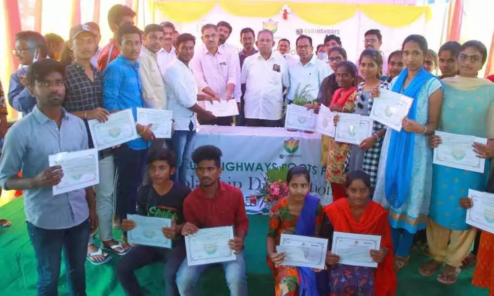 Cube Roots Foundation staff along with tenth class merit students at a programme at Toll Plaza building in Madugulapally on Friday