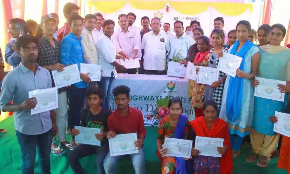Cube Roots Foundation staff along with tenth class merit students at a programme at Toll Plaza building in Madugulapally on Friday