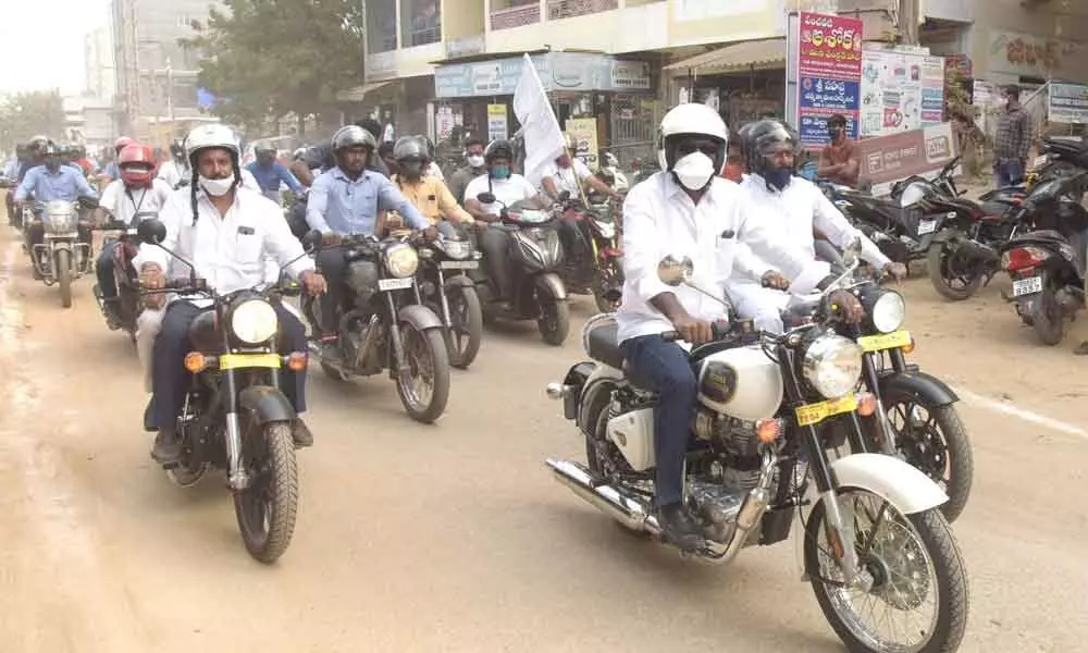 Transport Minister Puvvada Ajay Kumar participating in a bike rally held to educate people about road safety, in Khammam