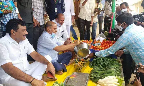 Chief Whip D Vinay Bhaskar selling organic vegetables at Rythu Bazaar in Hanamkonda on Saturday