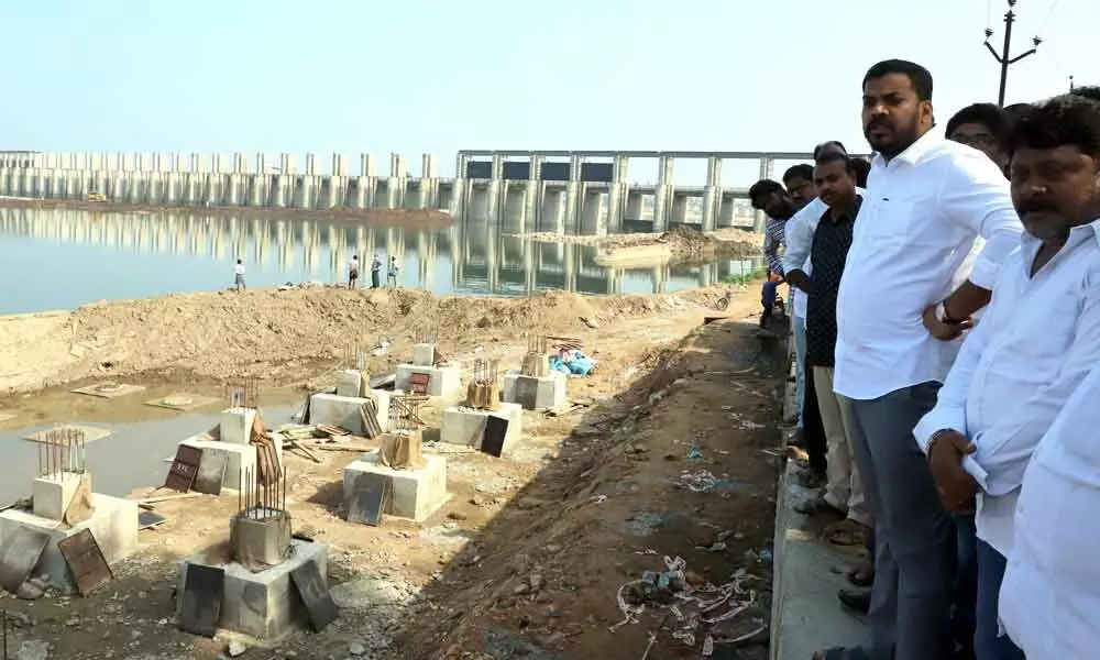 Minister Dr P Anil Kumar Yadav observing progress of works at the Penna barrage in Nellore on Sunday