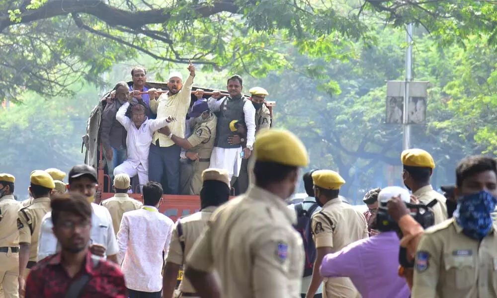 Police official arresting minority people as they are protesting for  re-constructing of Masjid in Secretariat, in Hyderabad on Sunday