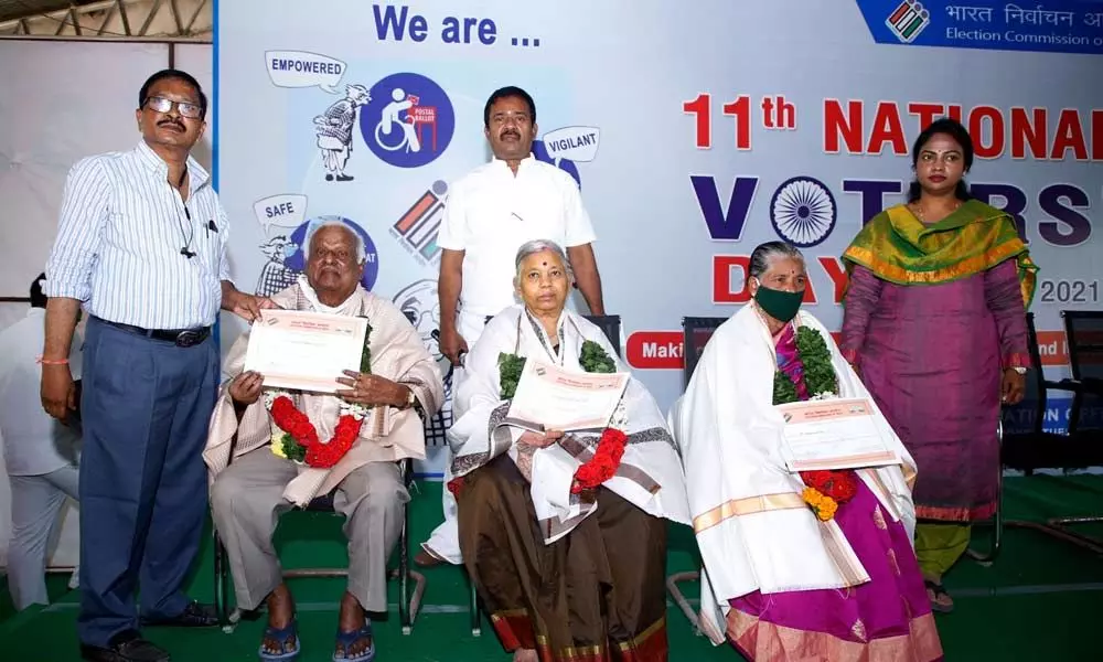 MCT Additional Commissioner D Haritha and urban tahsildar Venkataramana felicitating  senior citizens to mark National Voters’ Day celebrations  at municipal office in Tirupati on Monday