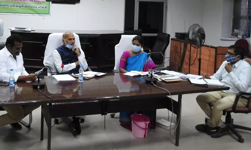 Rajya Sabha Member Alla Ayodhya Rami Reddy addressing a review meeting at GMC office in Guntur on Monday. GMC Commissioner Challa Anuradha also seen