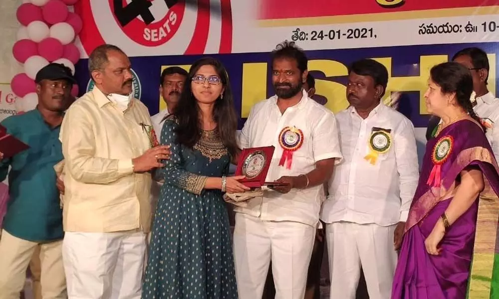 Sports and Youth Services Minister Dr V Srinivas Goud felicitating NEET rank student at a programme at Crown Garden function hall in Mahbubnagar on Monday.