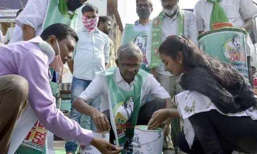 Leaders of various people’s organisations collecting farmers’ protection fund from people in Vijayawada on Monday