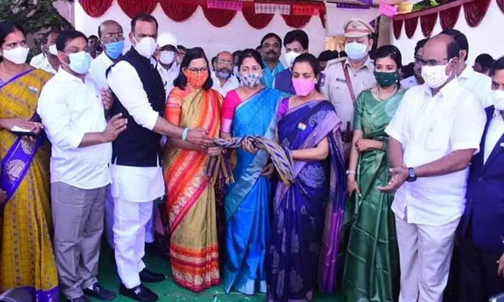 MP Komatireddy Venkat Reddy and District Collector Anita Ramachandran felicitating late Colonel Santosh Babus wife and trainee Deputy Collector B Santoshi during Republic Day celebrations at Bhongir on Tuesday