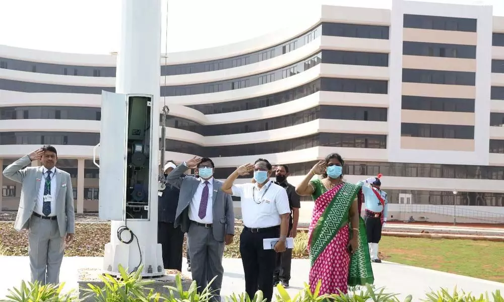 University officials saluting tricolour