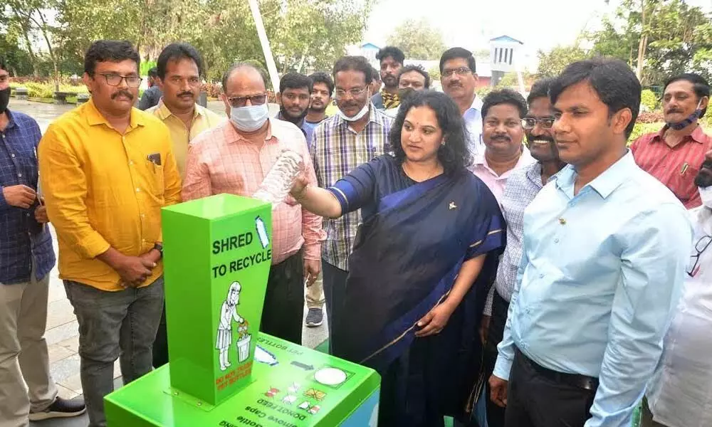 Municipal Commissioner G Srijana crushing a bottle at the newly installed machine in Visakhapatnam