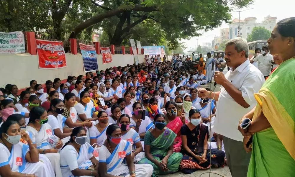 CITU State secretary K Umamaheswara Rao, Asha Workers Union district secretary P Kalpana addressing the protest in front of Collectorate in Ongole on Thursday