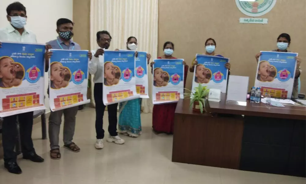 Joint Collector P Prasanti and district Task Force Committee members releasing posters relating to Pulse Polio programme in Guntur on Thursday