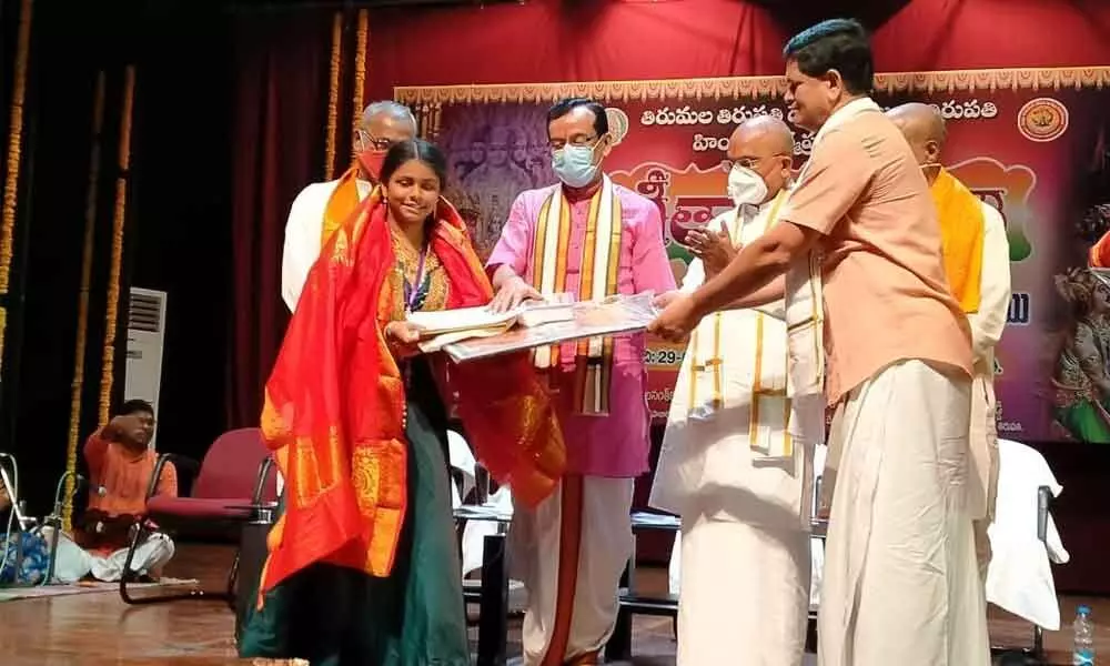 N Aiswarya being felicitated by the TTD EO and other officials for winning second prize in Bhagavad Gita recitation competition at Tirupati on Friday