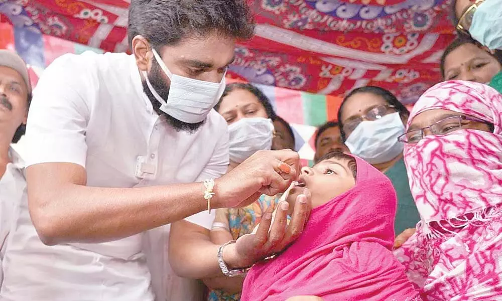 MP Margani Bharat administering polio drops to a kid in Rajamahendravaram on Sunday