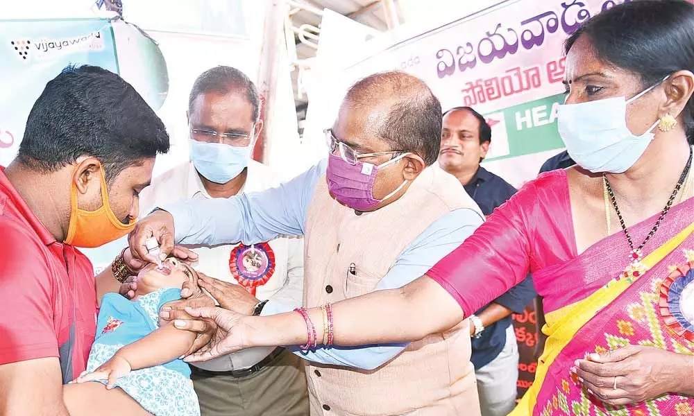 Krishna District Collector Md Imtiaz administering polio drops to a child  in Vijayawada on Sunday