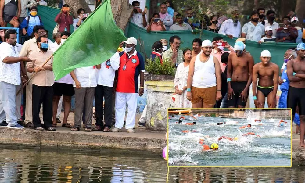 MLA Alla Ramakrishna Reddy flagging off swimming competition in Krishna river in Vijayawada on Sunday