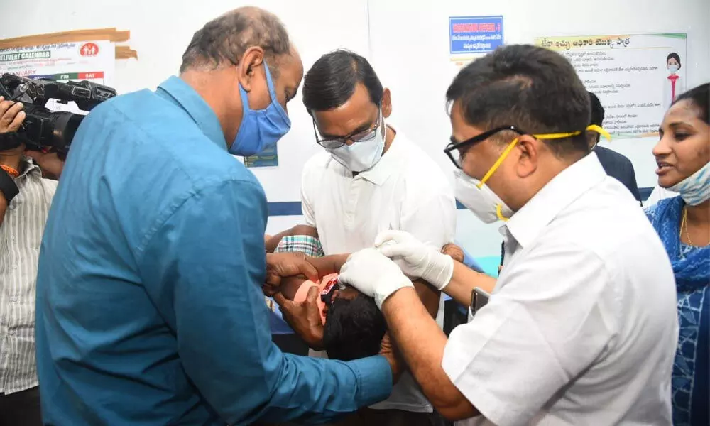 VMRDA Commissioner P Koteswara Rao getting his son administered pulse polio drops in Visakhapatnam.