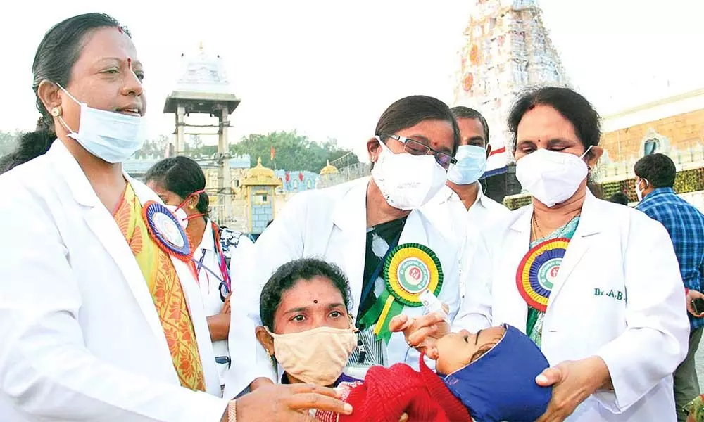 TTD Chief Medical Officer Dr A B Narmada administering polio drops to a child before Sri Vari Temple in Tirumala on Sunday.
