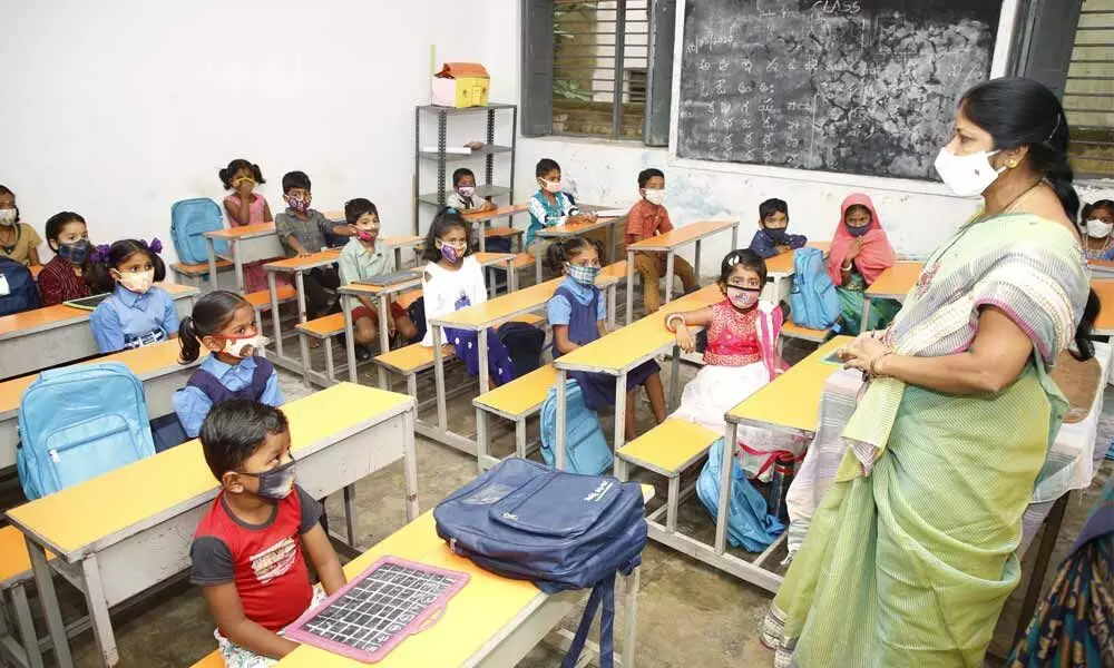 A teacher conducting class for children strictly following social distance norm at a Corporation primary school at Sarojinidevi Road in Tirupati on Monday