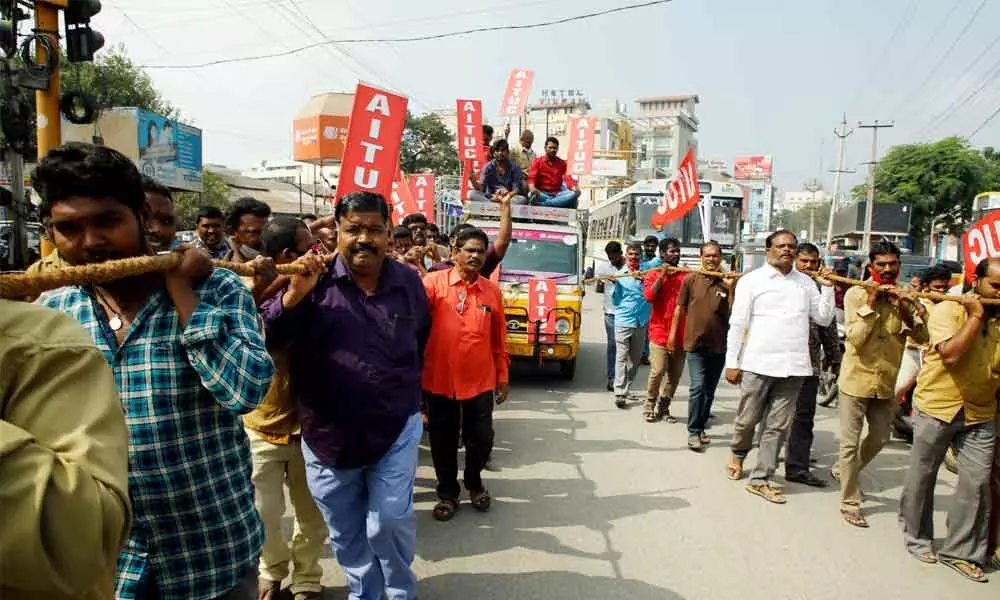 Auto, cab drivers and AITUC activists pulling a van with a rope as part of their protest against the hike in fuel prices in Tirupati  on Tuesday