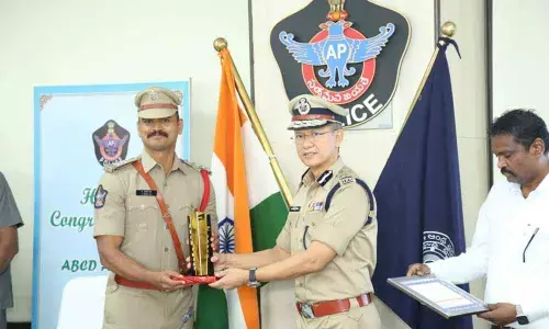 Nagari Circle Inspector Sadiq Ali receiving the ABCD award from DGP Gautham Sawang in Vijayawada on Friday.