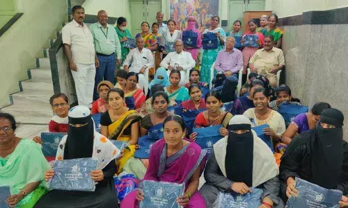 Founder  president of Avva Bank Rayachoti Ramaiah  distributing stitching bags to the women at  a programme  in Kurnool  on Saturday